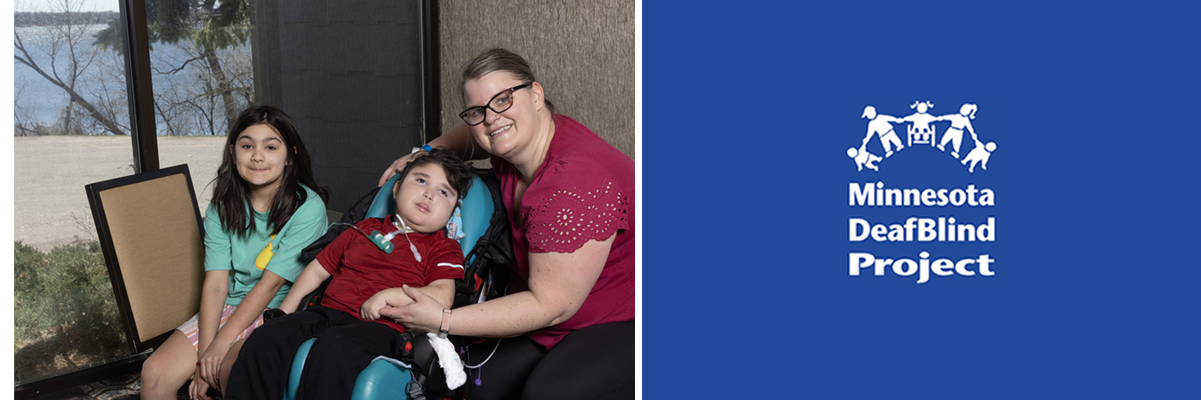 Photo of a family of three. All are light skinned and Mom has brown hair and is wearing glasses. Her young son is using an adapted stroller and has a tracheostomy and Mom holds his arm gently. The older sister sits behind her brother with dark hair. The whole family is smiling at the camera.