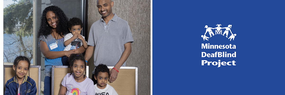 Photo of an Ethiopian American family. Pictured are mom and dad along with four children. Three young children are seated and mom and dad are standing behind them holding the youngest child. The whole family is smiling at the camera.